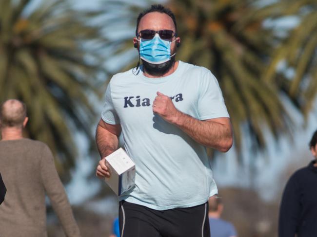 People exercising around Albert Park Lake. The Victorian Government has announced it will be mandatory from midnight on Wednesday to wear face coverings when out in public in Greater Melbourne and Mitchell Shire.Photograph by Paul JeffersThe Australian19 July 2020