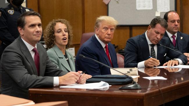 Donald Trump (C) listens to the indictment at the Manhattan Criminal Court. picture: AFP.