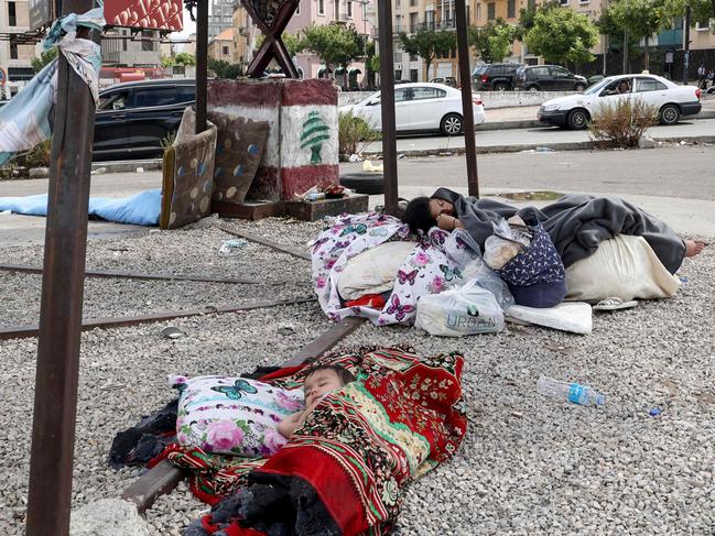 Displaced children sleep on the side walk in downtown Beirut. Picture: AFP.