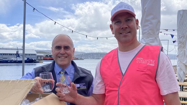 Hobart City Mission CEO Harvey Lennon, left, and Taste of Summer chair Jarrod Nation with the reusable wine glasses that will be sold at the festival.