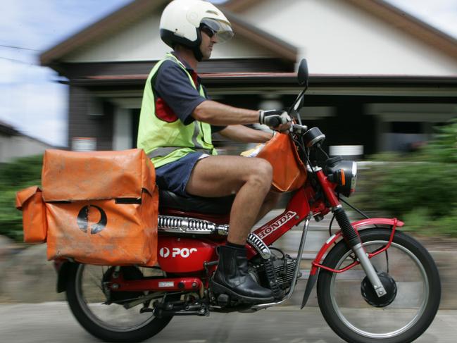 NEWS: Generic pic of an Australia Post worker (postman) on his motorbike (motorcycle) in Sydney. New regulations have raised the maximum weight for the rider from 95 to 105 kilograms.