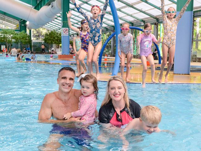 Opposition Leader Peter Malinauskas, with his daughter Eliza, and Adelaide Labor candidate Lucy Hood, with her son Ned, at the Adelaide Aquatic Centre in North Adelaide. Labor has announced plans to redevelop the site if they win the March election. Picture: Brenton Edwards