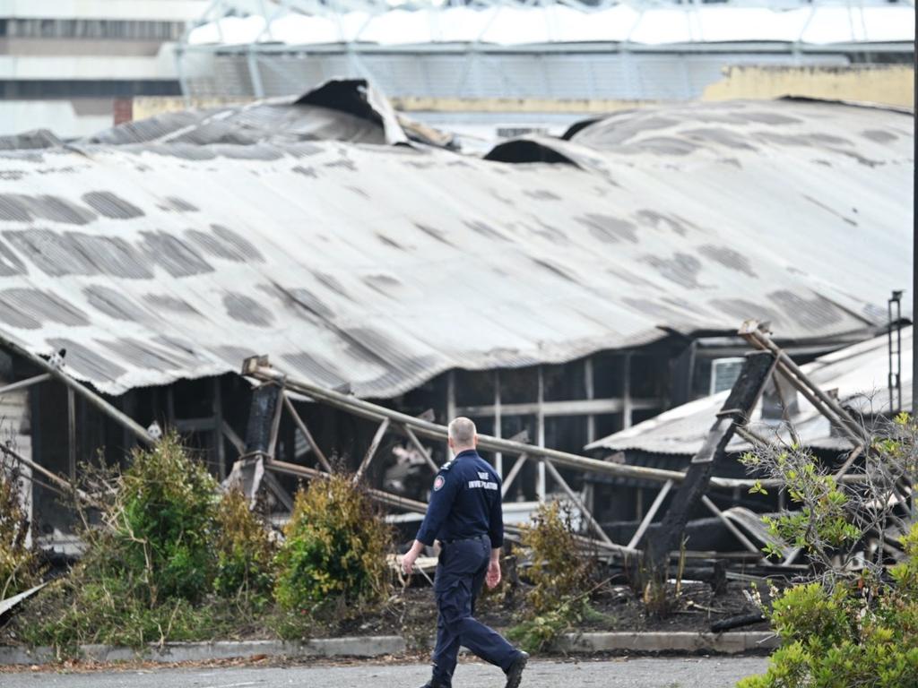 Police and fire investigators picture at the scene of yesterday’s fire at Woolloongabba. Picture Lyndon Mechielsen