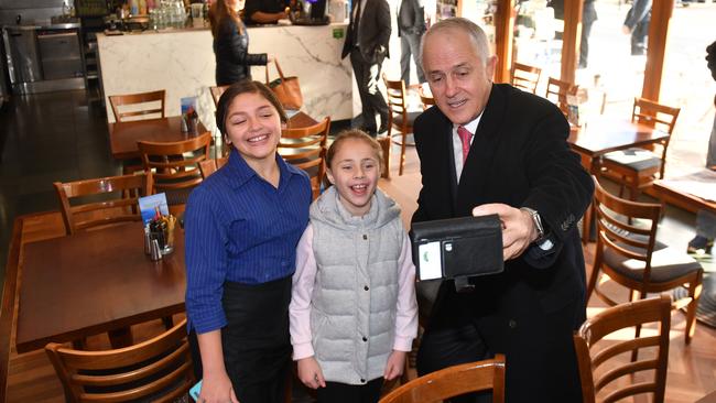 PM Malcolm Turnbull with Dimity-Maree Xenos and Jenna Xenos. Picture: AAP Image/Mick Tsikas