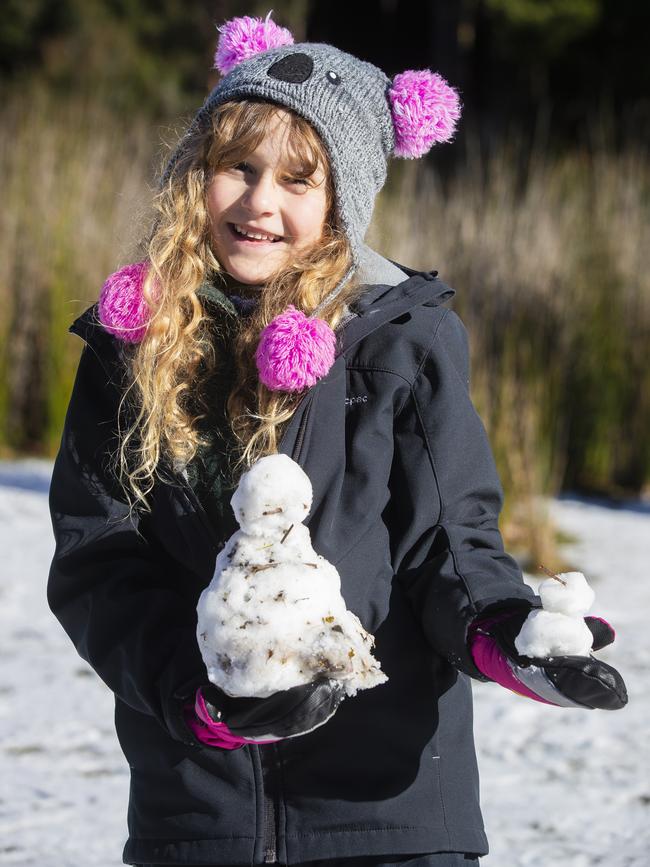 Isabella Braham, 7, with her snowman. Picture: RICHARD JUPE