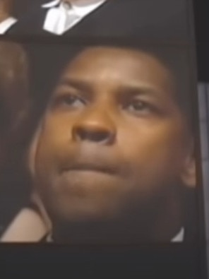 … as Denzel Washington watches on.