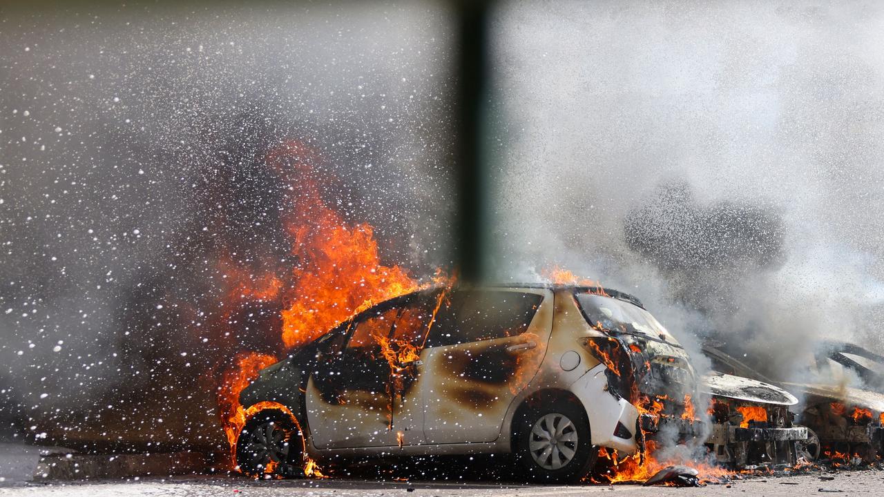 Cars are seen on fire following a rocket attack from the Gaza Strip in Ashkelon, southern Israel. Picture: Ahmad Gharabli / AFP