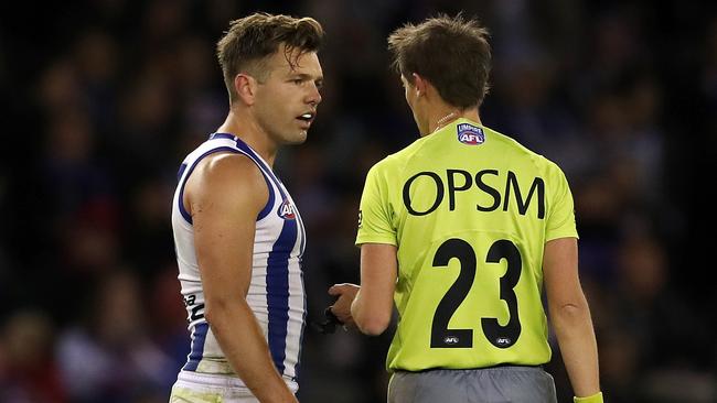 AFL Round 14. Western Bulldogs vs North Melbourne at the Etihad Stadium. North Melbourne's Shaun Higgins talks with umpire Robert Findlay after he was called to play on after taking too long to take a set shot at goal . Pic: Michael Klein