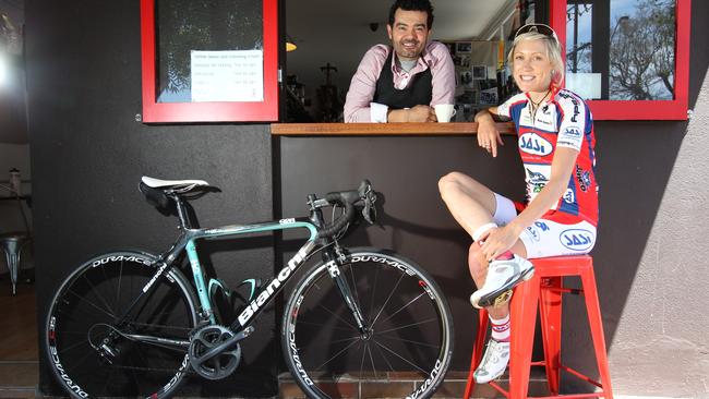 Cyclist Rachel Neylan at Red Berry Espresso with cafe owner Walter D'Addario. Photo: Tait Schmaal