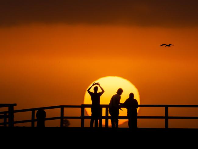 Sunset over Port Melbourne through bushfire smoke haze on Thursday evening. Picture: Jason Edwards