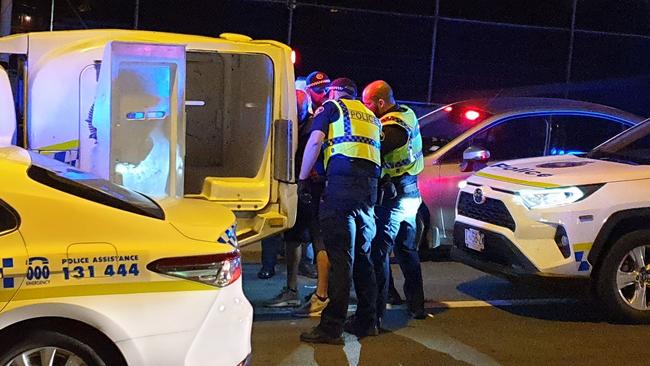 Police arresting a man on Sandy Bay Rd.