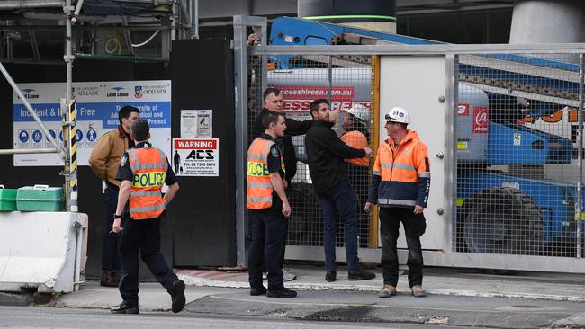 Police at the scene where two women were injured on Tuesday evening after a large metal gate fell on them at the Adelaide Medical and Nursing project on North Terrace in the CBD. Pic: Naomi Jellicoe