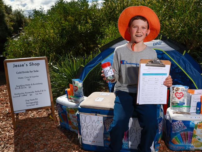 Jesse Lane, 12, serving customers and collecting signatures at his shop in Coogee. Picture: Justin Lloyd
