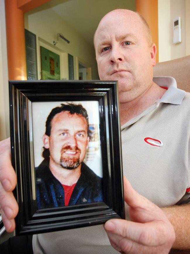 Paul Barker holding a photograph of his brother Shane.