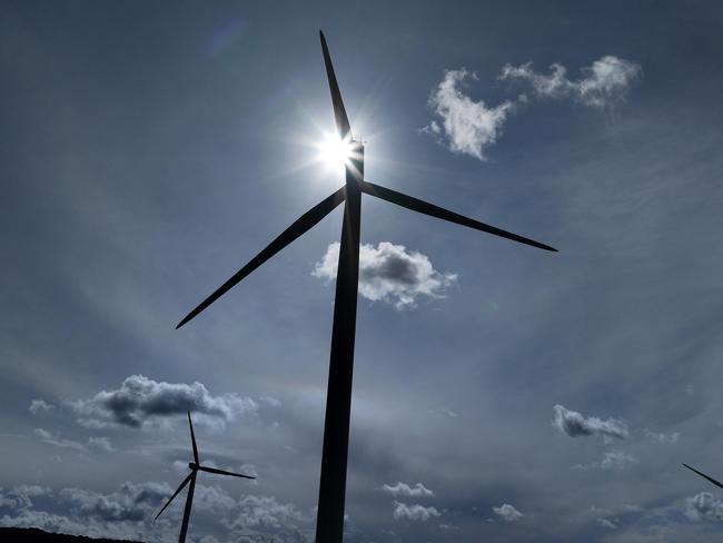 RUNCORN, ENGLAND - SEPTEMBER 21: Wind turbines generate electricity on September 21, 2023 in Runcorn, England. The Prime Minister has announced the postponement of several 