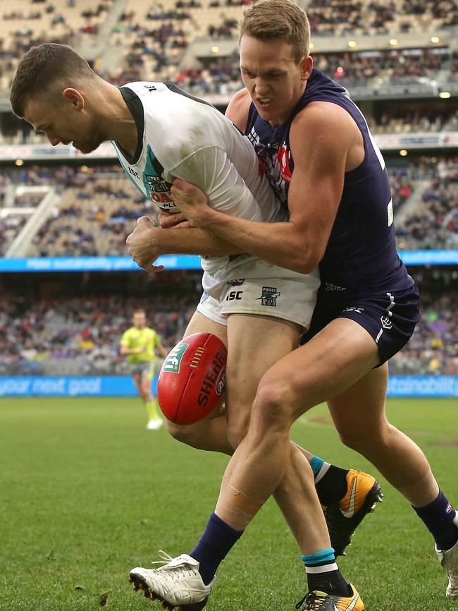 Ryan Nyhuis of the Dockers tackles Robbie Gray of the Power. Picture: Paul Kane/Getty Images