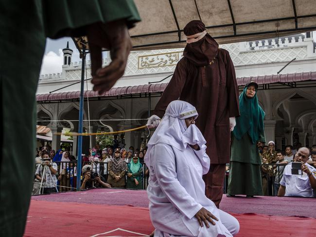 A woman in Aceh gets caning in public for spending time with a man who is not her husband, which is in violation against sharia law. Picture: Ulet Ifansasti/Getty Images