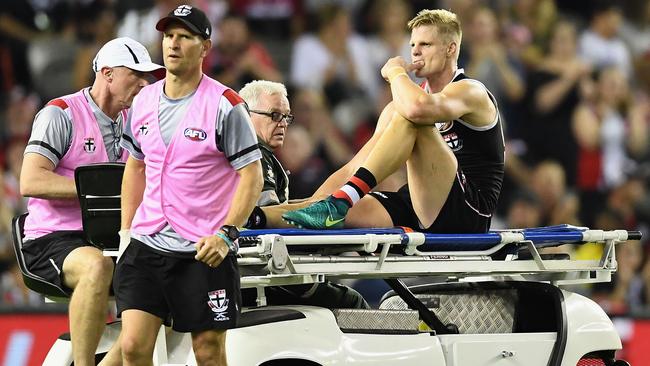 Nick Riewoldt is stretchered off after injuring his knee.