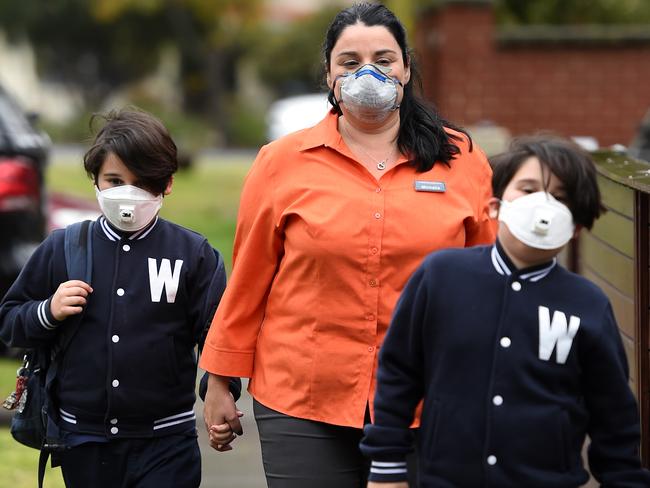 Jonah Accaputo 8, Micah Accaputo 8 were picked up from school by their mum Michell Accaputo after Wembley Primary School in Yarraville closed for the afternoon due to the toxic smoke in the air from the Factory fire off Sommerville road West Footscray, Melbourne. Picture: Nicole Garmston