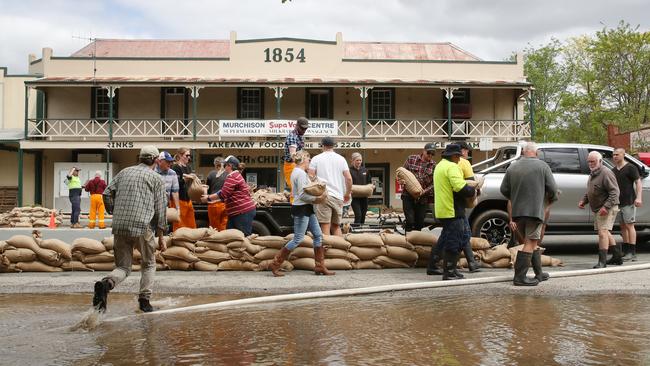 Locals, CFA and SES battle to save Murchison from rising flood waters from the Goulburn River in 2022. Picture: David Crosling