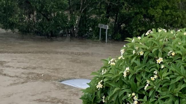 Charlotte Mitchell’s car roof could only just be seen above the flood water at its peak during Saturday's Gold Coast floods. Picture: Supplied.