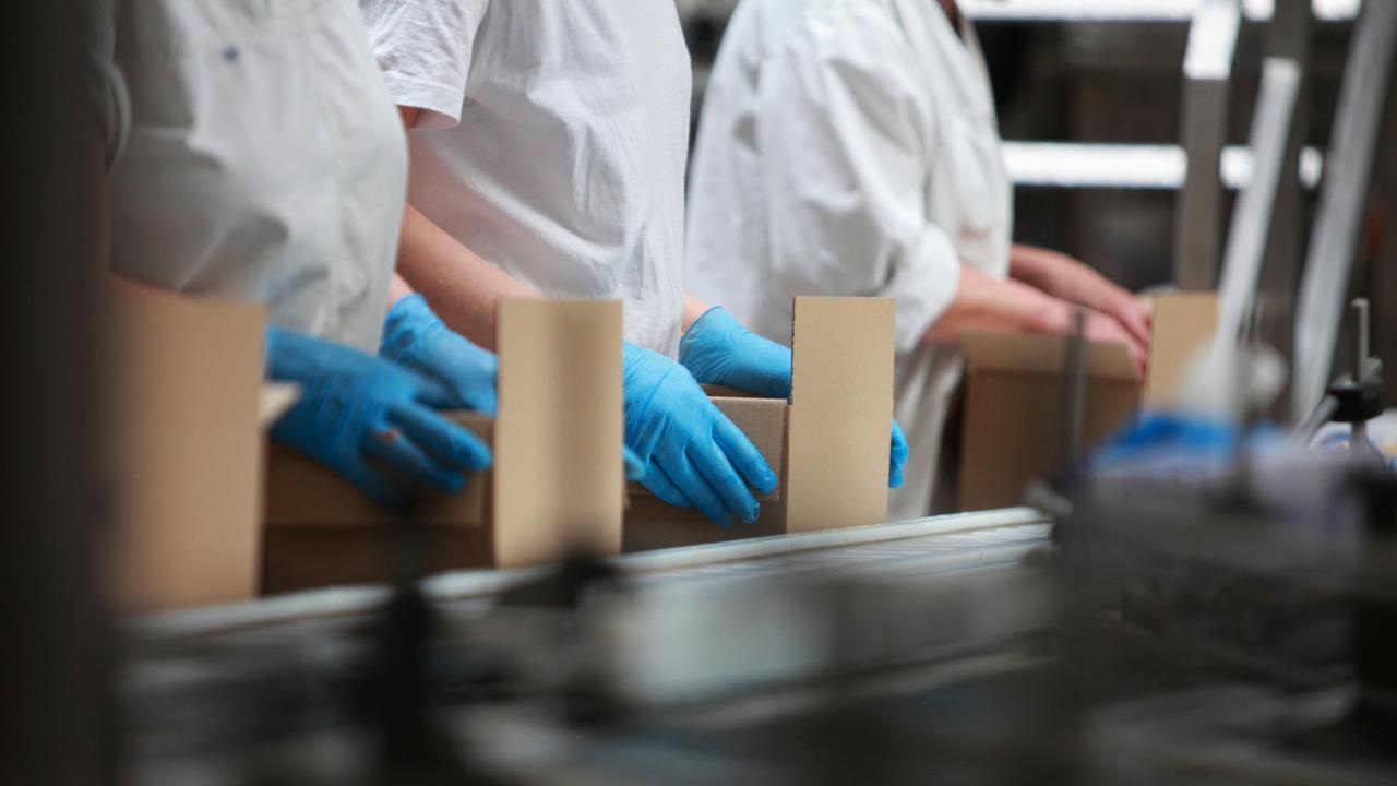 People working on packing line in factory - close up Picture: Istock