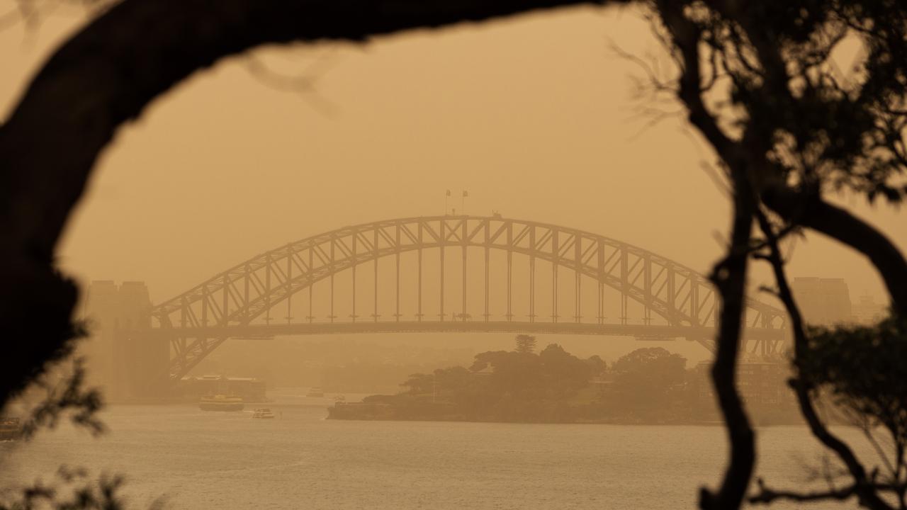 The Sydney Harbour Bridge is seen through smoke haze from bushfires on Tuesday. Picture: AAP Image/Paul Braven.