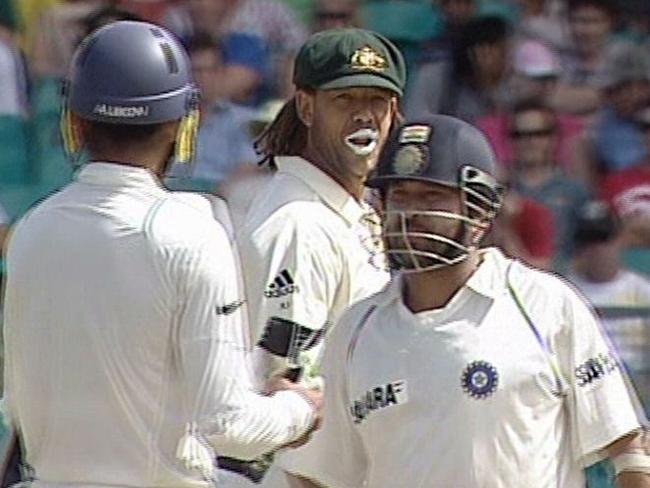 Indian batsman Harbhajan Singh (L) and opponent Andrew Symonds have words as fellow batsman Sachin Tendulkar looks on.