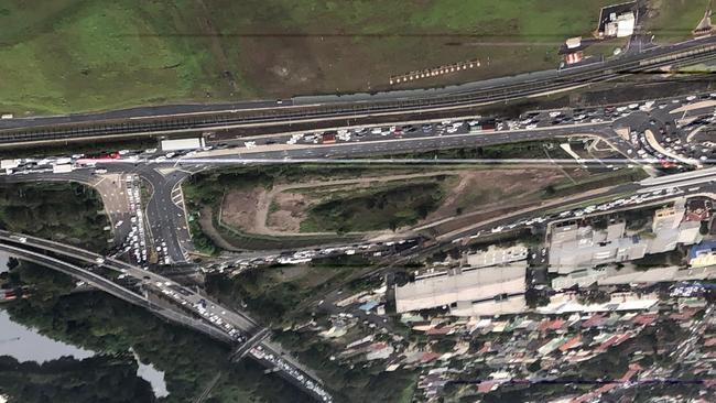 Traffic backed up on Sydney's M5 after one person died and three were seriously injured in a crash, blocking the airport tunnel on General Holmes Drive. Picture: Nicholas Gray