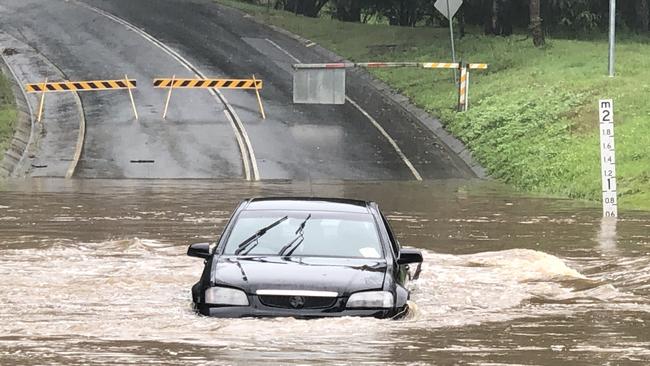 A Holden Commodore in floodwater on Hardys Road at Mudgeeraba . Picture: Glenn Hampson