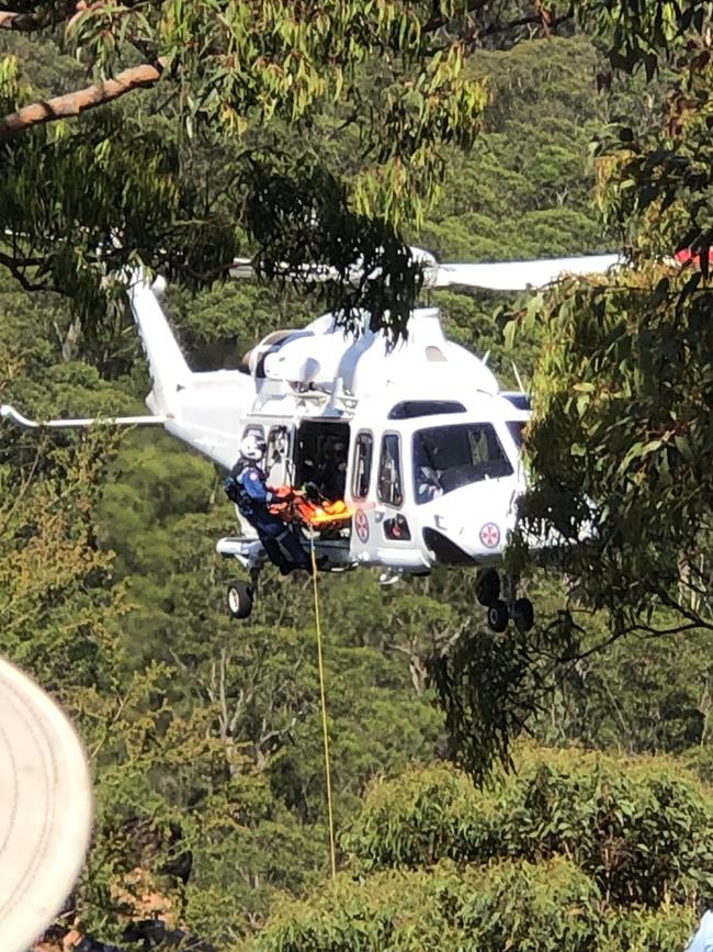 The man is being winched to safety. Picture: Sue Blackford