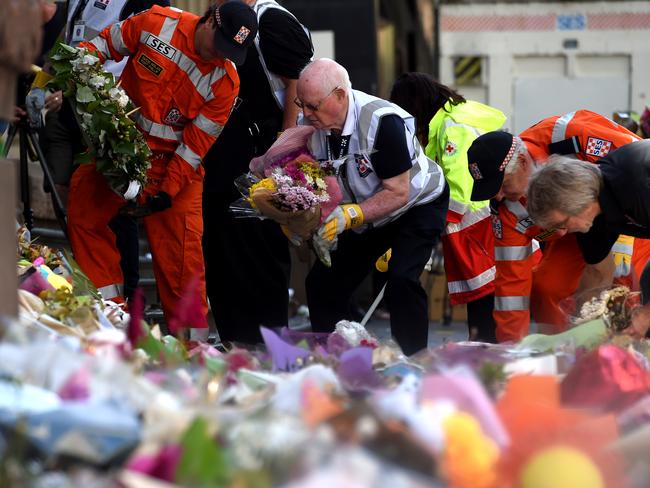 Dozens of helpers removing the flowers. Picture: Nicole Garmston