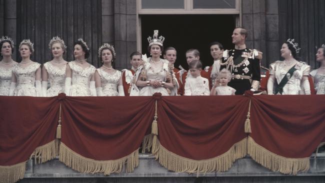 Queen Elizabeth II and the Duke of Edinburgh wave at the crowds from the balcony of Buckingham Palace in London, after Elizabeth's coronation in 1953.