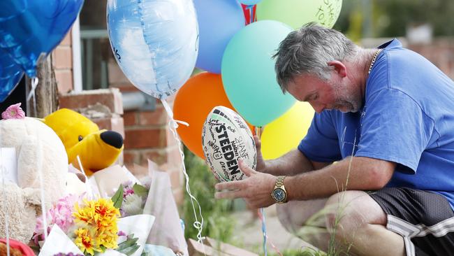 Father Joseph Shorey pays his respects to his two sons, Shane and Sheldon. Picture: Jonathan Ng