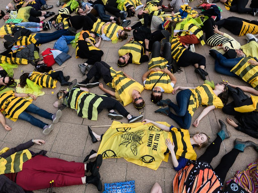 Protesters dressed as bees stage a ‘die-in’ in Sydney. Picture: AAP Image/James Gourley