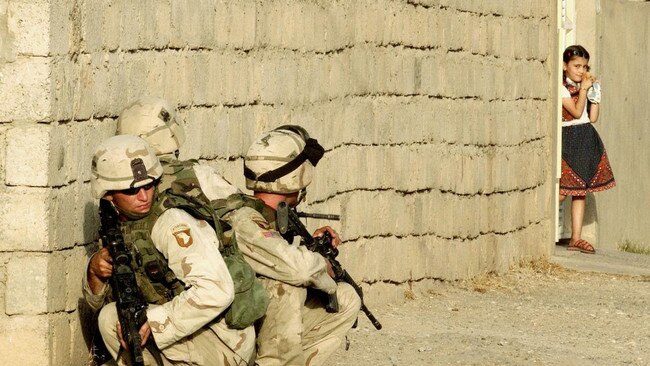 A stark divide between civilian and military life in Mosul, July 22, 2003. Picture: Getty Images/The Times