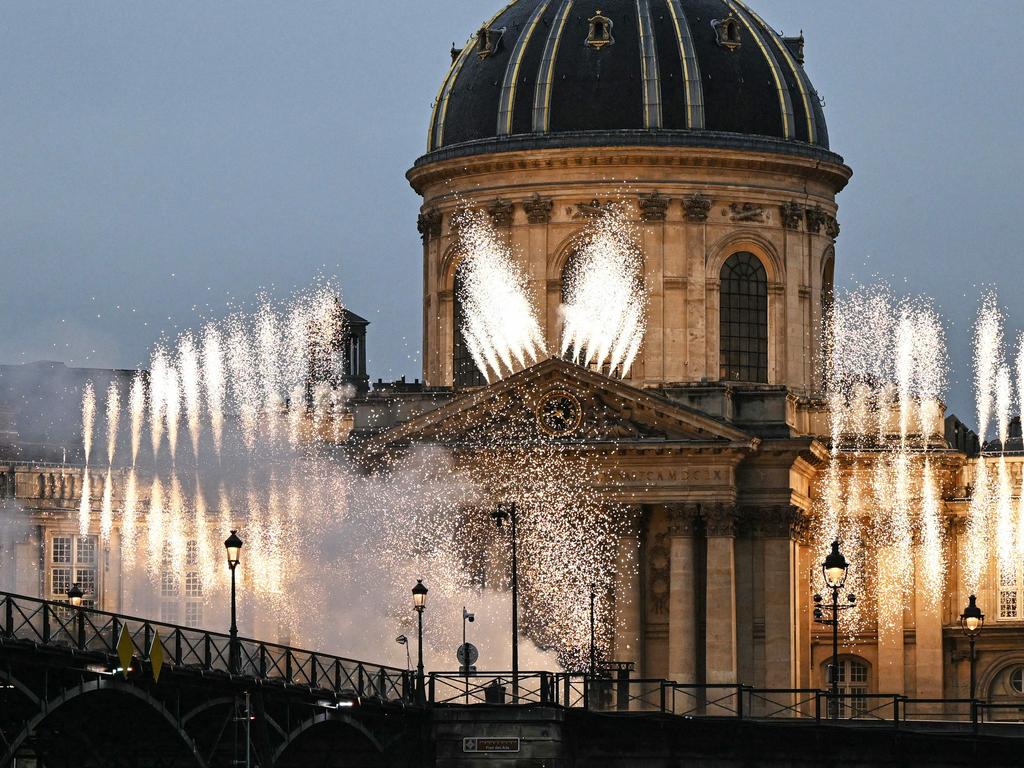 The Institut de France is illuminated with fireworks during the opening ceremony of the Paris 2024 Olympic Games in Paris on July 26, 2024. (Photo by Kirill KUDRYAVTSEV / AFP)