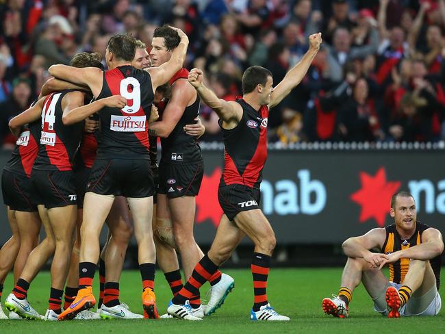 Jubilant Essendon players, Jarryd Roughead inconsolable.