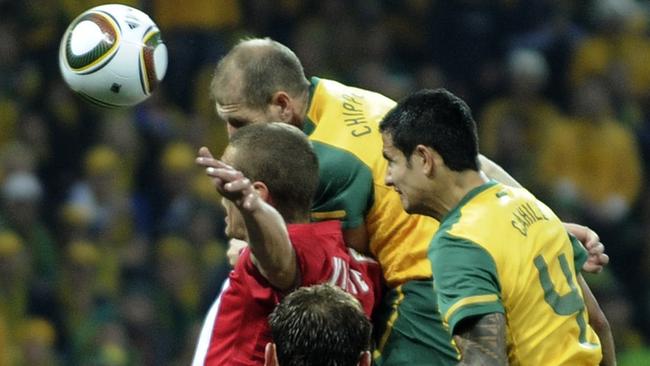 Tim Cahill (right) rises above the Serbian defence to score for the Socceroos at the 2010 World Cup in South Africa. Picture: AP