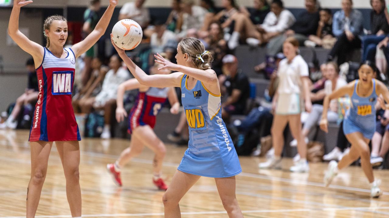 Krista Hughes (left) for Darling Downs defends against Rylee Jones of Peninsula in Queensland School Sport 16-19 Years Girls Netball Championships at Clive Berghofer Arena, St Mary's College, Friday, May 6, 2022. Picture: Kevin Farmer