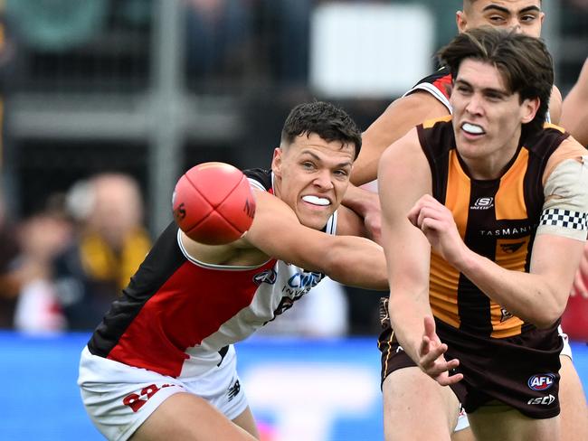 Day handballs under pressure from Saints tagger Marcus Windhager. Picture: Steve Bell/Getty Images