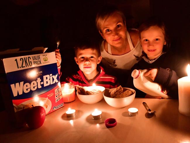 28/9/16. Flood Watch. Susanna Parkinson with her kids Octavia - 7yrs and Banjo - 5yrs eating dinner by candle light Pic: Keryn Stevens