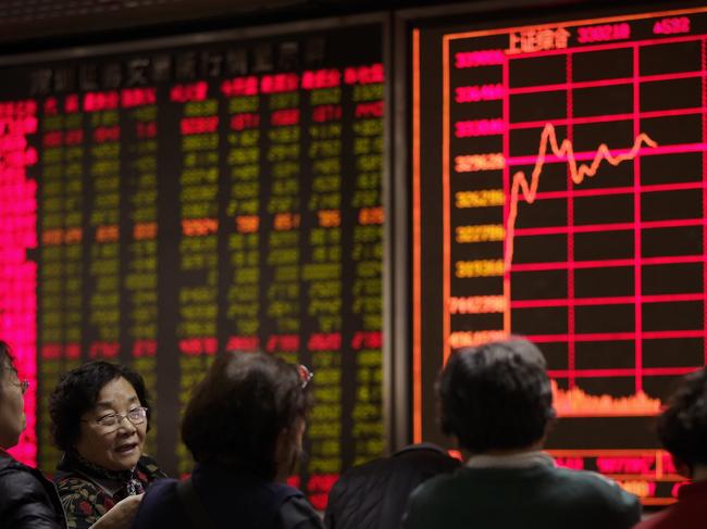 Women chat with each other in front of an electronic board displaying stock prices at a brokerage house in Beijing, Tuesday, Jan. 5, 2016. Last year’s Chinese stock boom and disastrous bust has left a legacy of public distrust of financial markets along with a bill the ruling party has yet to disclose for its rescue. The Shanghai index ended 2015 up 9.5 percent for the year, compared with a 0.7 percent loss for Wall Street’s Standard & Poor’s 500 index. But many novices who bought just before the peak are left with shares worth less than they cost. (AP Photo/Andy Wong)