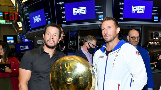 Actor Mark Wahlberg and F45 CEO Adam Gilchrist pose on the trading floor as F45 Training rings the opening bell at the New York Stock Exchange in 2021. Picture: Noam Galai/Getty Images for F45 Training