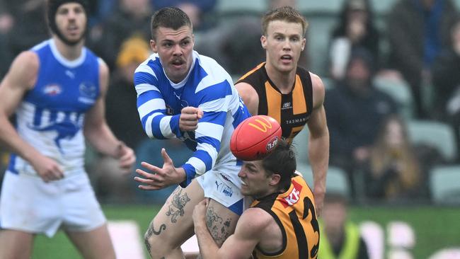 LAUNCESTON, AUSTRALIA - AUGUST 24: Cameron Zurhaar of the Kangaroos is tackled by Dylan Moore of the Hawks during the round 24 AFL match between Hawthorn Hawks and North Melbourne Kangaroos at University of Tasmania Stadium, on August 24, 2024, in Launceston, Australia. (Photo by Steve Bell/AFL Photos/via Getty Images)