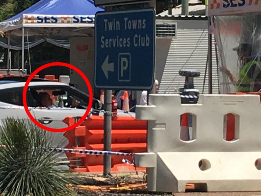 A driver passes through a checkpoint at Coolangatta holding her mobile phone. Picture: NCA / NewsWire Darren Cartwright