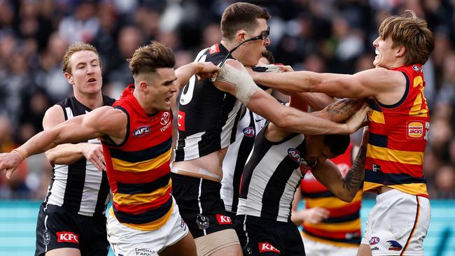 Ben Keays of the Crows removes the glasses of Mason Cox. Picture: Getty