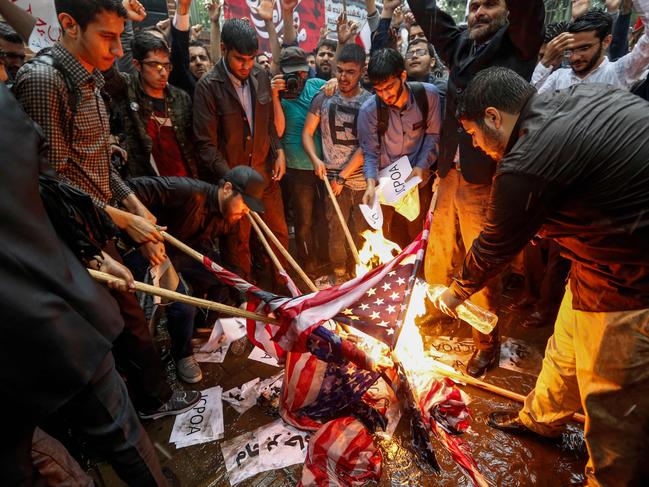 Iranians burn US flags and makeshift Israeli flags in Tehran. Picture: AFP