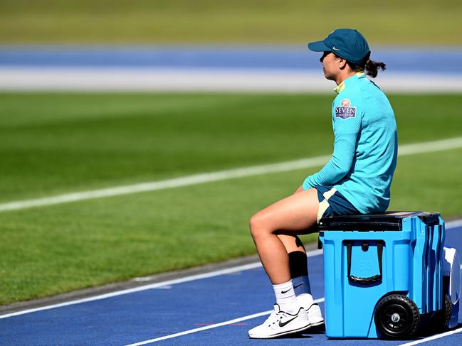 A dejected Sam Kerr watches her Matildas teammates train on Sunday. Picture: Bradley Kanaris/Getty Images