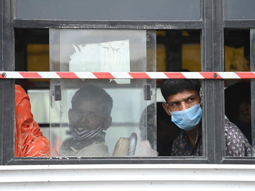 People sit on a bus in New Delhi on April 20, 2021 to leave for their native places. Picture: Sajjad Hussain/AFP